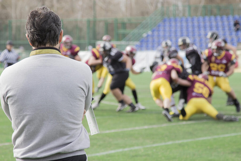 Coach observing football match