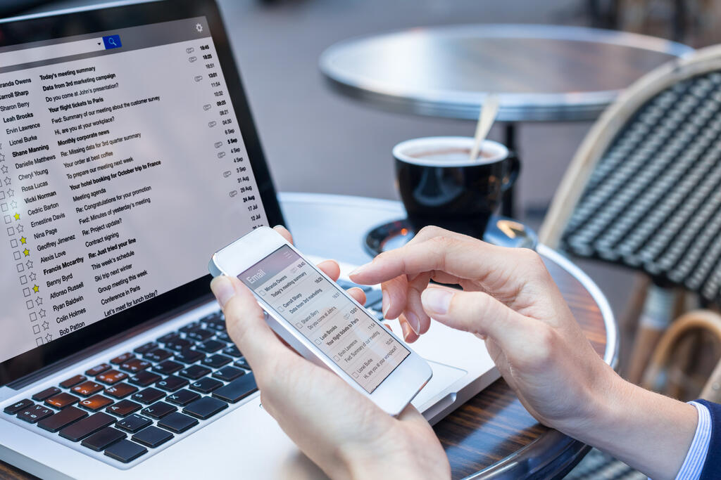 Business person reading emails on smartphone and laptop computer screen online, communication and marketing concept